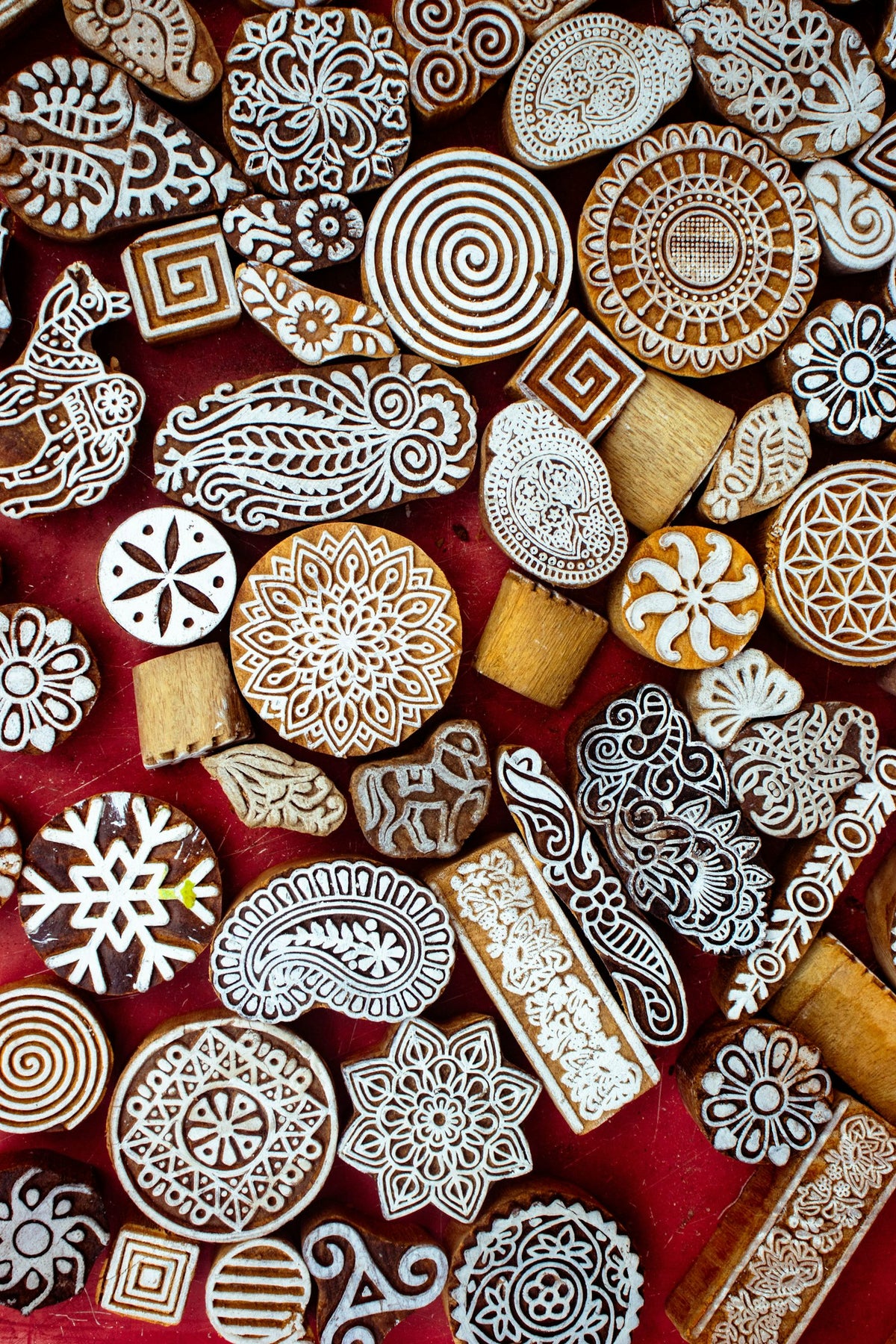 Hand-carved wooden block printing stamps arranged on fabric